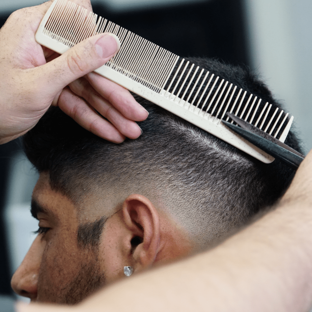 Client getting a fade at West Palm Beach barbershop Ascend The Trend