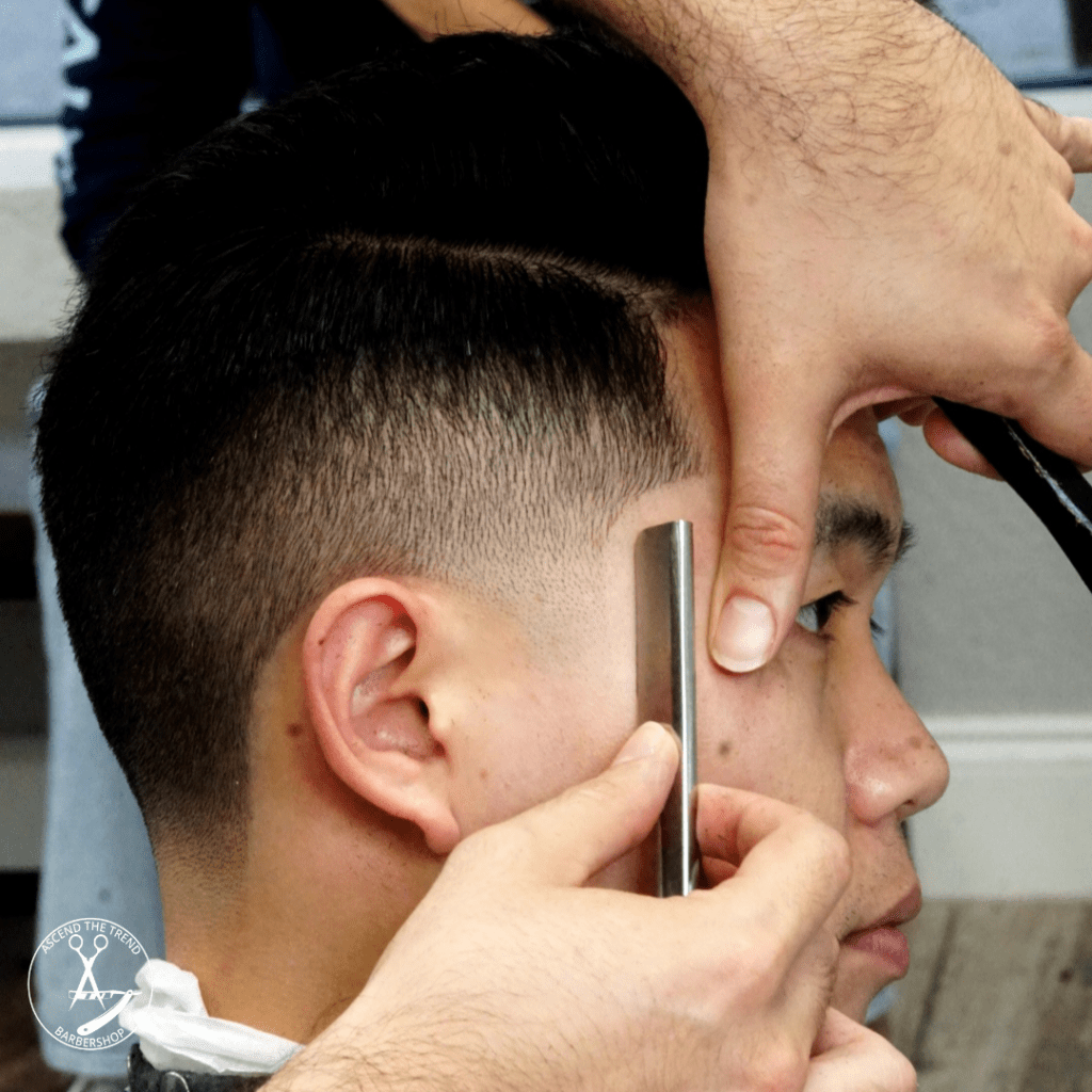 Master barber giving skin fade haircut in downtown West Palm Beach